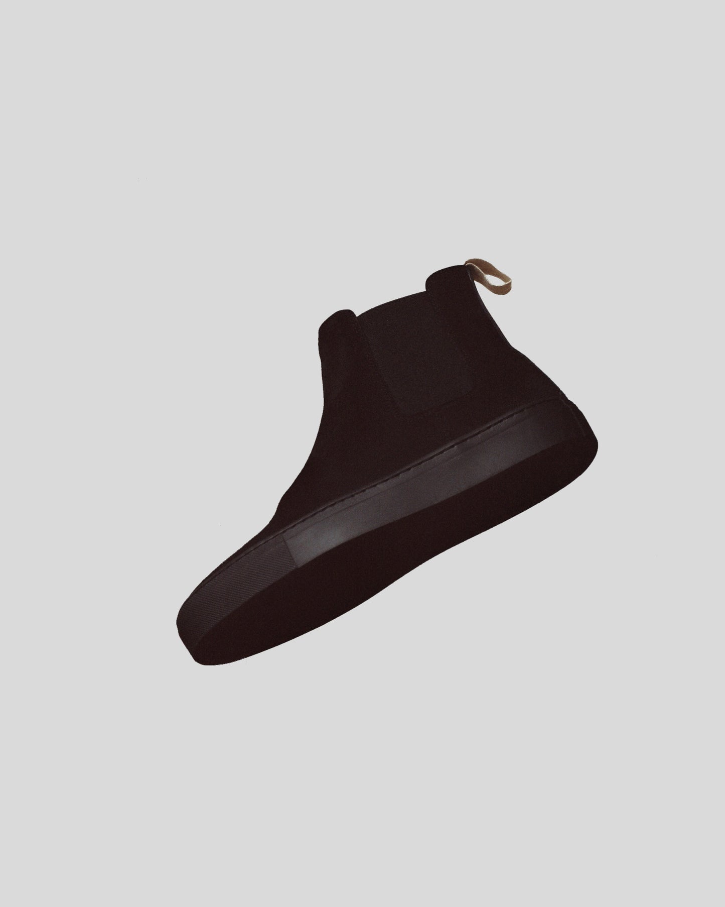 Black slip-on sneaker on a light gray background